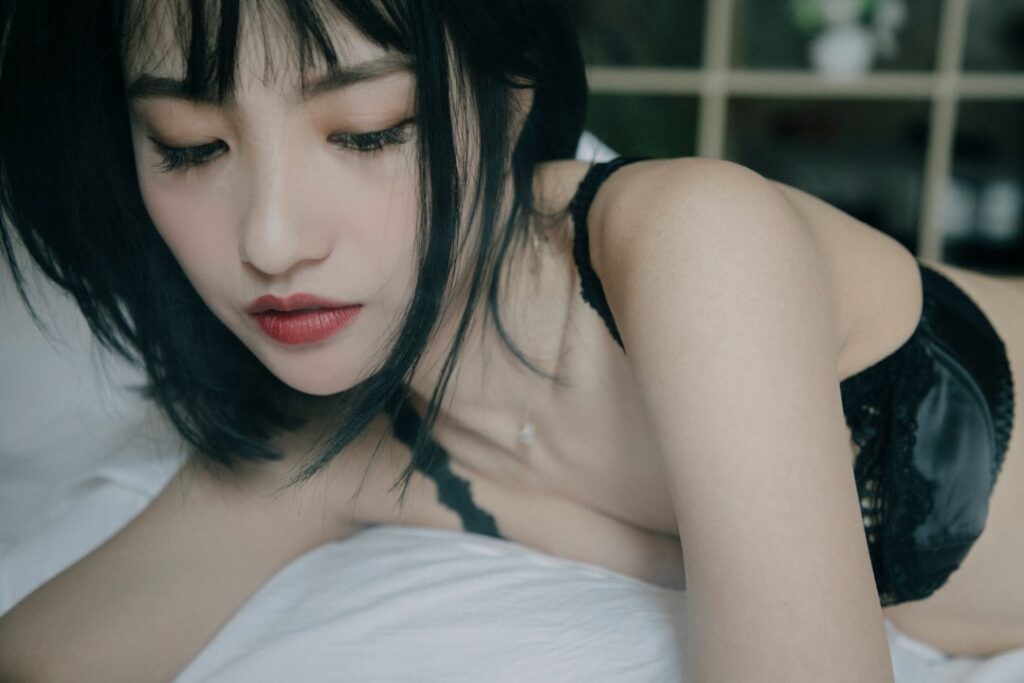 a woman laying in bed with her eyes closed