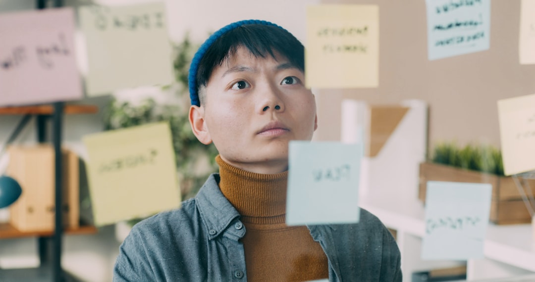 A man standing in front of a bunch of post it notes